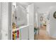 Functional laundry room with stacked washer and dryer, and storage shelves at 806 N Waccamaw Dr. # 104, Murrells Inlet, SC 29576