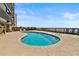 Beautiful private pool area with ocean view, lounge chairs and nearby beach access at 806 N Waccamaw Dr. # 104, Murrells Inlet, SC 29576