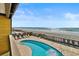 Stunning view of the private pool, beach and ocean from the balcony of this condo at 806 N Waccamaw Dr. # 104, Murrells Inlet, SC 29576
