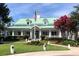 Community clubhouse features a covered porch, large windows, and beautiful landscaping at 808 East Coast Ln., North Myrtle Beach, SC 29582