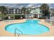 Sparkling community pool and hot tub surrounded by lush landscaping and comfortable seating at 808 East Coast Ln., North Myrtle Beach, SC 29582