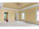 Open bedroom area with a ceiling fan, neutral carpeting, and two large windows for natural light at 808 East Coast Ln., North Myrtle Beach, SC 29582