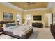 Main bedroom features en suite bathroom, updated furnishings, large windows, and a statement ceiling at 808 East Coast Ln., North Myrtle Beach, SC 29582