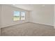 A well-lit, carpeted bedroom featuring a pair of large, bright windows at 814 S Midway Hwy., Johnsonville, SC 29555