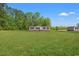 A charming single story house with a lush green lawn and a backdrop of mature trees on a sunny day at 814 S Midway Hwy., Johnsonville, SC 29555