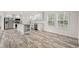 Bright kitchen featuring white cabinets, modern appliances, a center island, and wood-look floors at 814 S Midway Hwy., Johnsonville, SC 29555