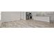 Open living space featuring wood-look floors, modern appliances, white cabinets, and lots of natural light at 814 S Midway Hwy., Johnsonville, SC 29555