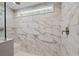 A modern shower with marble-style tiled walls, a sleek showerhead, and a glass enclosure at 814 S Midway Hwy., Johnsonville, SC 29555