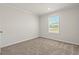 Sunlit bedroom featuring new carpeting, a window with views, and neutral wall paint at 820 S Midway Hwy., Johnsonville, SC 29555