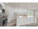 Modern kitchen with a large island, white cabinets, and granite countertops at 820 S Midway Hwy., Johnsonville, SC 29555