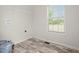 Functional laundry room with modern flooring, and ample natural light from a window at 820 S Midway Hwy., Johnsonville, SC 29555