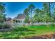 Large backyard with a well-manicured lawn, white picket fence and mature trees at 8261 Timber Ridge Rd., Conway, SC 29526