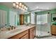 Bright bathroom featuring double sinks and a glass enclosed shower with tiled walls at 8261 Timber Ridge Rd., Conway, SC 29526