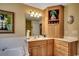 Bathroom featuring a soaking tub with tiled backsplash and vanity with marble countertop and light wood cabinets at 8261 Timber Ridge Rd., Conway, SC 29526