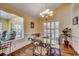 Elegant dining room with hardwood floors, chandelier, and large windows offering views of the backyard at 8261 Timber Ridge Rd., Conway, SC 29526