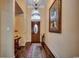 Inviting foyer with hardwood floors, an elegant chandelier, and an arched transom window above the front door at 8261 Timber Ridge Rd., Conway, SC 29526