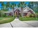 Beautiful brick home featuring a well-manicured lawn, mature landscaping and a spacious driveway at 8261 Timber Ridge Rd., Conway, SC 29526