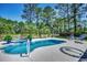 Backyard pool features a palm tree design on the concrete and plenty of seating for relaxing at 8261 Timber Ridge Rd., Conway, SC 29526