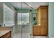 Bright bathroom featuring a glass enclosed shower with tiled walls and a large window at 8261 Timber Ridge Rd., Conway, SC 29526