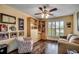 Cozy sitting room with hardwood floors, custom bookshelves, and large window at 8261 Timber Ridge Rd., Conway, SC 29526