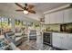 Comfortable sunroom features stylish furniture, a beverage fridge and many windows at 8261 Timber Ridge Rd., Conway, SC 29526