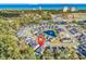 Aerial view of a neighborhood with pond, pool, and ocean views in the background at 8418 Cape Dutch Loop, Myrtle Beach, SC 29572