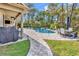 Beautiful backyard featuring a pool, spa, outdoor seating, and lush landscaping at 8418 Cape Dutch Loop, Myrtle Beach, SC 29572