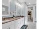Modern bathroom featuring double sinks, white cabinets and a walk-in closet at 8418 Cape Dutch Loop, Myrtle Beach, SC 29572