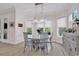 Sunlit dining area with modern light fixture, neutral walls, and serene backyard views at 8418 Cape Dutch Loop, Myrtle Beach, SC 29572