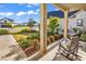 Inviting front porch with rocking chairs, plants, and a view of the lush green lawn at 8418 Cape Dutch Loop, Myrtle Beach, SC 29572