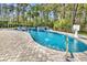 An outdoor swimming pool with spa, basketball hoop, and lush greenery in the backyard at 8418 Cape Dutch Loop, Myrtle Beach, SC 29572