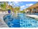 Backyard pool with in-pool lounge chairs and a fountain feature surrounded by lush landscaping at 8418 Cape Dutch Loop, Myrtle Beach, SC 29572
