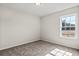 Bright, carpeted bedroom with a window showcasing natural light and outdoor views at 875 Owls Nest Dr., Conway, SC 29527