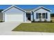 Charming one-story home with a blue exterior, well-manicured lawn, and a convenient two-car garage at 875 Owls Nest Dr., Conway, SC 29527