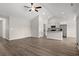 Open concept living space featuring hardwood floors, vaulted ceiling, ceiling fan and modern kitchen at 875 Owls Nest Dr., Conway, SC 29527