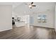 Bright, open-concept living space featuring hardwood floors, a ceiling fan, and modern kitchen with stainless appliances at 875 Owls Nest Dr., Conway, SC 29527