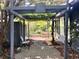 Backyard patio featuring a pergola, brick pathway and fenced yard at 915 Cedarwood Circle, Myrtle Beach, SC 29572