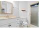Bathroom featuring a single sink vanity with drawers, a mirror, and a walk-in shower at 915 Cedarwood Circle, Myrtle Beach, SC 29572