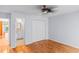 Bedroom showcasing hardwood floors, ceiling fan, and adjacent bathroom and closet at 915 Cedarwood Circle, Myrtle Beach, SC 29572