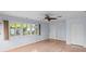 Bright bedroom featuring hardwood floors, a ceiling fan, and large windows with exterior views at 915 Cedarwood Circle, Myrtle Beach, SC 29572