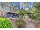Landscaped front yard with colorful flowers, wooden pergola, and walkway to home at 915 Cedarwood Circle, Myrtle Beach, SC 29572
