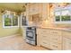Kitchen view with stainless steel oven, custom cabinets, decorative tile backsplash, and tiled floor at 915 Cedarwood Circle, Myrtle Beach, SC 29572