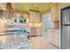 Updated kitchen boasts stainless steel appliances, custom cabinets, and granite countertops at 915 Cedarwood Circle, Myrtle Beach, SC 29572