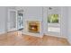 Living room with a white fireplace, wooden flooring, and natural light pouring in from the windows and patio at 915 Cedarwood Circle, Myrtle Beach, SC 29572
