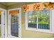 Bright sunroom showcasing a window with a view of mature trees and lush vegetation at 915 Cedarwood Circle, Myrtle Beach, SC 29572
