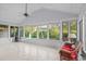 Bright sunroom with many windows, tiled floor, and wicker furniture at 915 Cedarwood Circle, Myrtle Beach, SC 29572