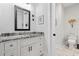 Elegant bathroom featuring granite countertops, white cabinets, and decorative accents at 1006 Surf Pointe Dr., North Myrtle Beach, SC 29582