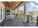 Spacious covered patio with stone fireplace and dining area overlooking a serene lake at 1006 Surf Pointe Dr., North Myrtle Beach, SC 29582