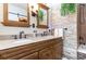 Bathroom featuring a granite countertop, double sinks, and a stone-accented wall at 101 Maddington Place Dr. # 103, Surfside Beach, SC 29575