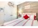 Cozy bedroom featuring a bed with red accents, a wood accent wall, and coastal decor for a relaxed ambiance at 101 Maddington Place Dr. # 103, Surfside Beach, SC 29575